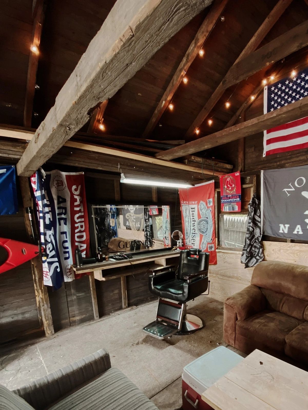 The original garage barbershop: one barber chair, string lights and flags